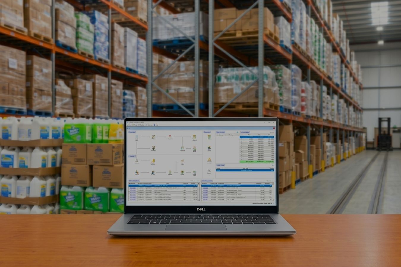 PJ Enterprise Software | Wholesale Inventory Management Solutions PUREJOIN's PJ Enterprise wholesale management software displayed on a laptop inside a distribution warehouse, showcasing inventory tracking and business operations.
