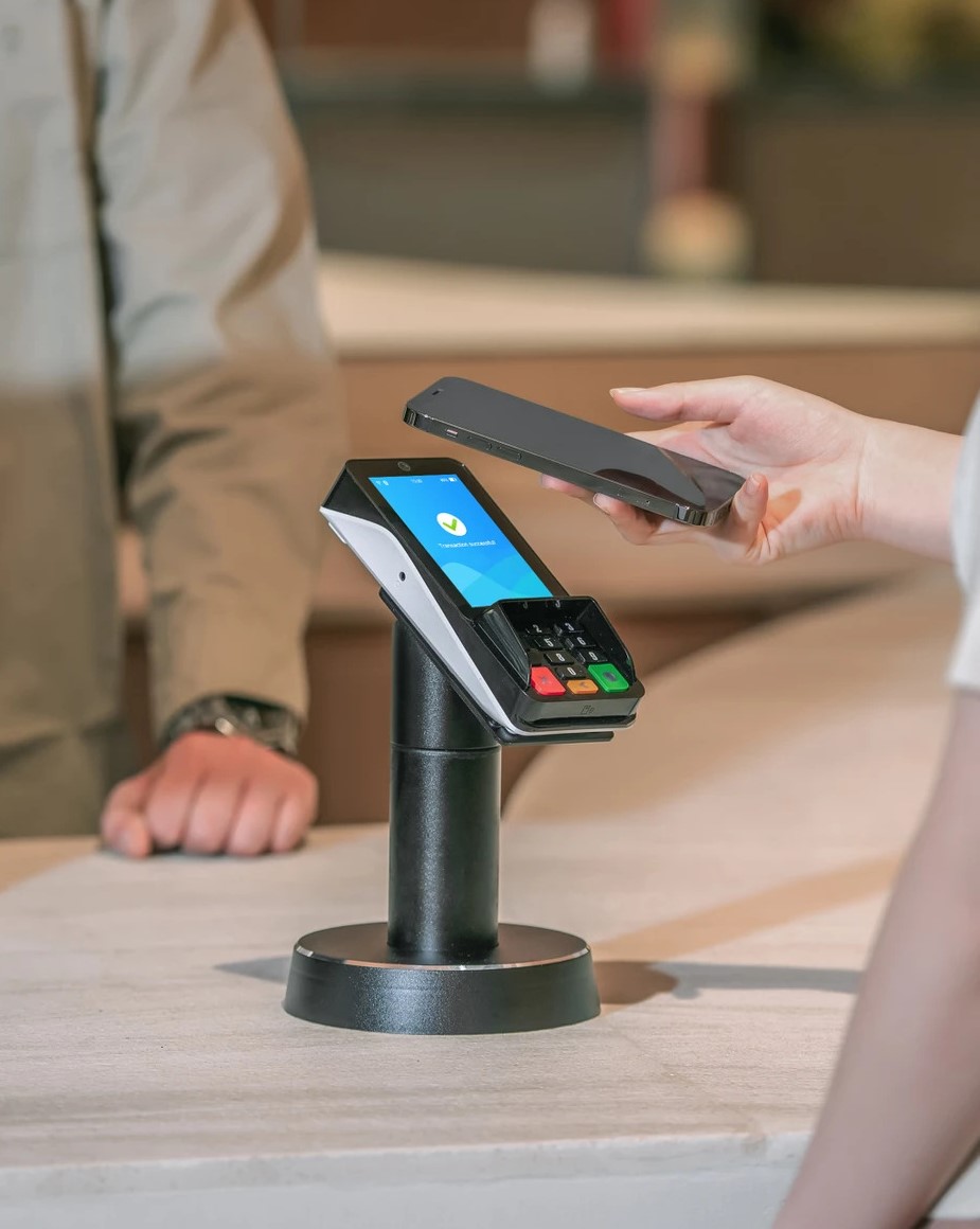 PAX A35 Contactless Payment Terminal | Retail Payment Processing PAX A35 credit card terminal processing a contactless smartphone payment, offering secure retail payment processing solutions and merchant services.